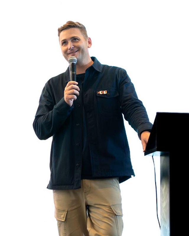 Benjamin Latsko speaking on stage